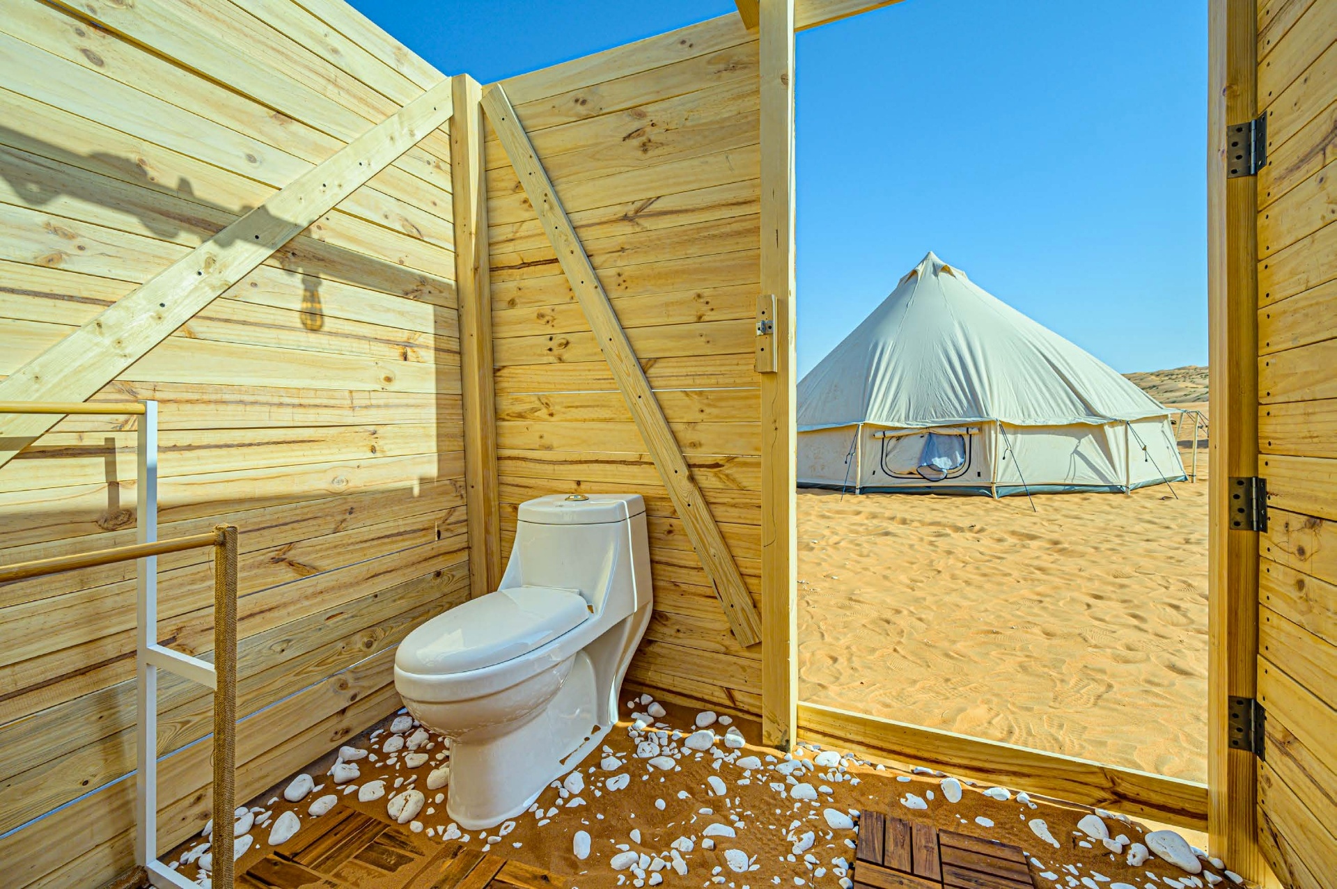 Private wooden desert bathroom with shower and toilet at Twilight Dunes