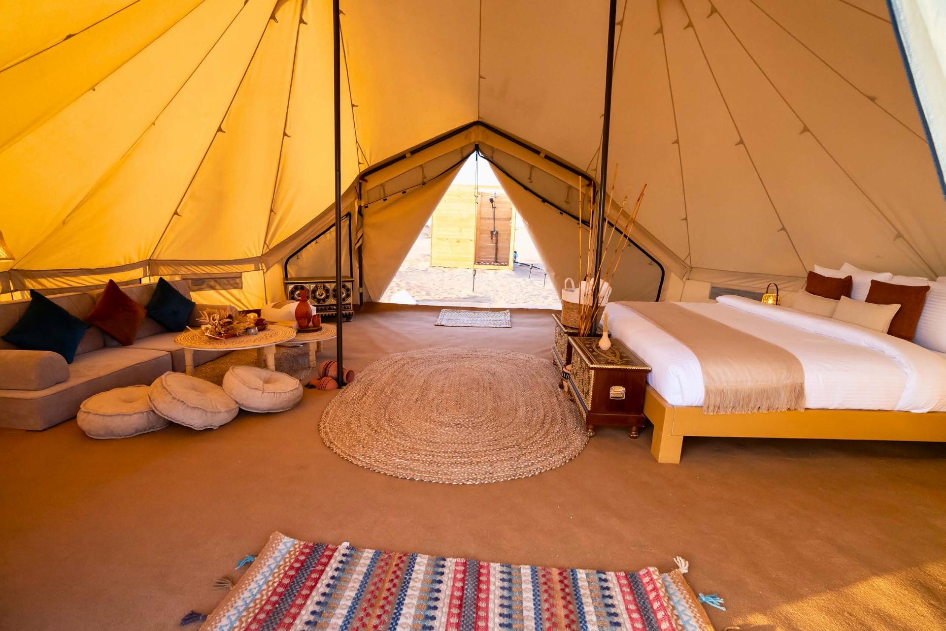Interior of a glamping eco tent with king bed and Omani decor