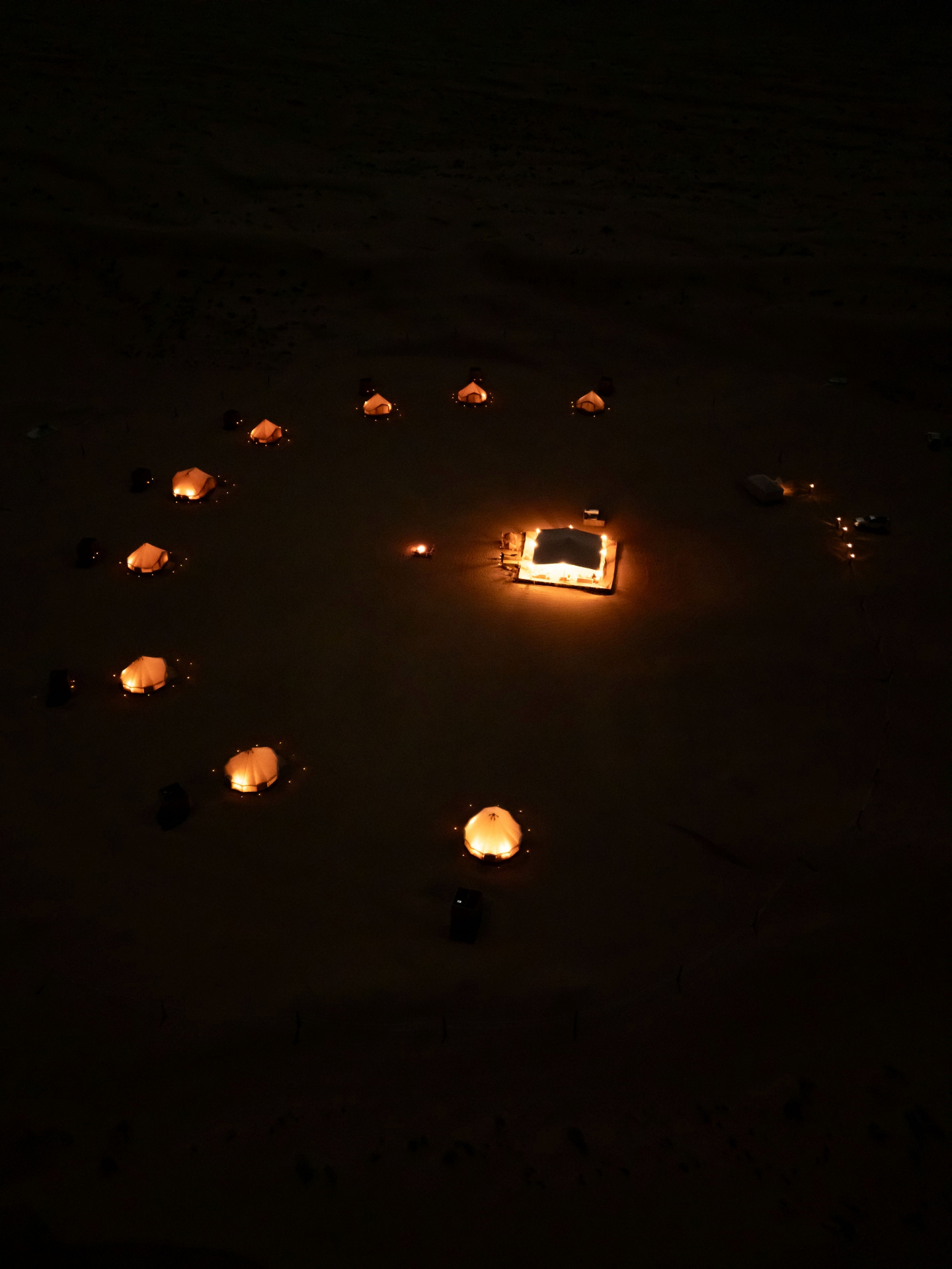 Desert glamping camp lit at night