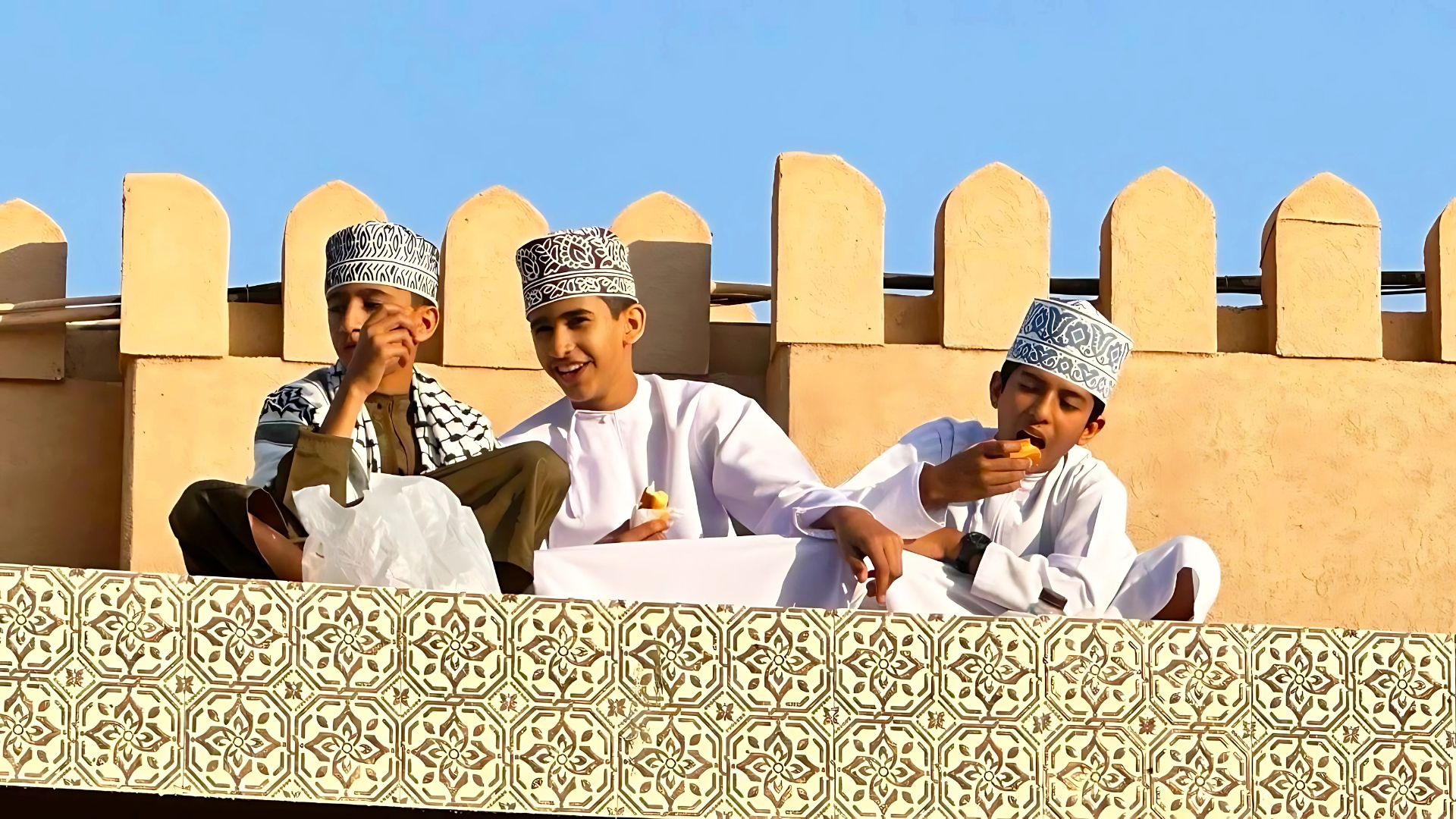 Young Omani boys on a fort rooftop